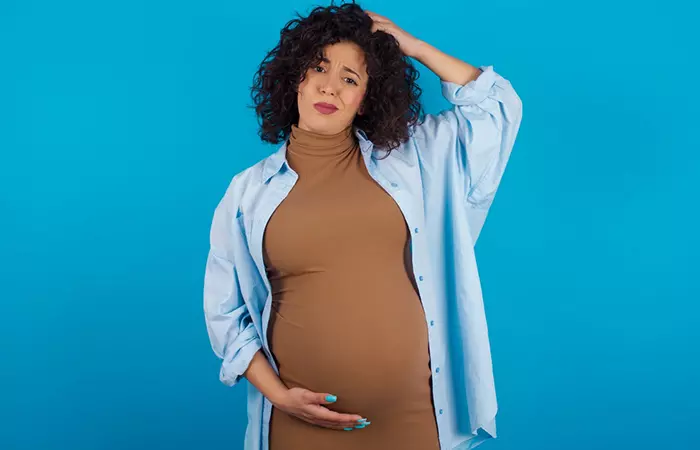 Беременная женщина задается вопросом, безопасно ли делать химическую завивку волос во время беременности.